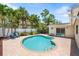 Backyard featuring a kidney-shaped pool, brick patio, and lush landscaping, perfect for relaxation at 4739 114Th N St, St Petersburg, FL 33708