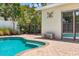 Close-up of the pool, bench, and landscaping highlighting the backyard oasis at 4739 114Th N St, St Petersburg, FL 33708