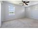 Bright bedroom with large windows offering picturesque lake views and a ceiling fan at 4743 Somerset Hill Ln, Riverview, FL 33578