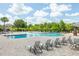 Beautiful community pool area with ample seating, lush landscaping, and a covered pavilion at 4743 Somerset Hill Ln, Riverview, FL 33578