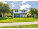 Charming two-story home featuring a well-manicured lawn and covered porch with a screened in lanai at 4743 Somerset Hill Ln, Riverview, FL 33578