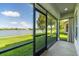 Enjoy outdoor living on this screened lanai overlooking the serene lake and lush green lawn at 4743 Somerset Hill Ln, Riverview, FL 33578