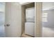 Conveniently located laundry closet with stacked washer and dryer unit for space-saving efficiency at 4743 Somerset Hill Ln, Riverview, FL 33578