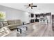 Open-concept living space featuring modern kitchen, comfortable seating, and stylish flooring at 4743 Somerset Hill Ln, Riverview, FL 33578