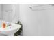 Stylish powder room with a pedestal sink, modern fixtures, and neutral decor at 4743 Somerset Hill Ln, Riverview, FL 33578