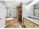 Bright bathroom featuring a tub, tiled shower, and granite countertops at 4920 Anniston Cir, Tampa, FL 33647