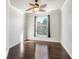 Bedroom with wood floors, ceiling fan, and a view from the window at 4920 Anniston Cir, Tampa, FL 33647