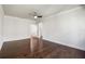Spacious bedroom with dark hardwood floors, white walls, and a ceiling fan at 4920 Anniston Cir, Tampa, FL 33647