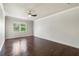 Spacious bedroom featuring hardwood floors, neutral walls, ceiling fan, and natural light at 4920 Anniston Cir, Tampa, FL 33647