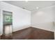 Bedroom featuring hardwood floors, neutral walls, and a bright window for ample natural light at 4920 Anniston Cir, Tampa, FL 33647