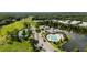 Aerial view of community amenities including a pool, clubhouse, lake and tennis courts at 4920 Anniston Cir, Tampa, FL 33647