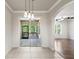 Dining room with tile flooring, pendant lighting, sliding glass doors to lanai, and open floor plan at 4920 Anniston Cir, Tampa, FL 33647
