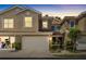 Two-story townhome at sunset with an attached garage and cozy entrance at 4920 Anniston Cir, Tampa, FL 33647