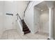 Spacious foyer features tile flooring, staircase with wood treads and decorative railing at 4920 Anniston Cir, Tampa, FL 33647