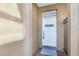 Front door in an alcove with a welcome sign on a white six-panel door at 4920 Anniston Cir, Tampa, FL 33647