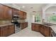 Spacious kitchen with granite countertops, stainless steel appliances, and custom wood cabinetry at 4920 Anniston Cir, Tampa, FL 33647