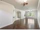 Open living room with hardwood floors, neutral walls, ceiling fan, and windows offering natural light at 4920 Anniston Cir, Tampa, FL 33647