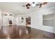 Open-concept living room with hardwood floors, ceiling fans, and an arched doorway at 4920 Anniston Cir, Tampa, FL 33647