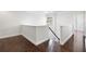 Second floor loft space with hardwood floors, neutral walls, and staircase with decorative railing at 4920 Anniston Cir, Tampa, FL 33647
