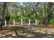Entrance to Oak Park with signage and walking path in a lush, green setting at 4920 Anniston Cir, Tampa, FL 33647