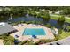 Aerial view of the community pool, featuring lounge chairs and lush landscaping at 4920 Anniston Cir, Tampa, FL 33647