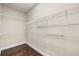 Walk-in closet with wire shelving and dark wood floors at 4920 Anniston Cir, Tampa, FL 33647