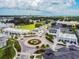 Aerial view of a charming community features a roundabout and shops, showcasing the neighborhood's layout and landscaping at 5120 Marina Way # 15005, Tampa, FL 33611