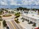 Overhead view of a community, showcasing commercial buildings, a roundabout, roads, and manicured landscaping at 5120 Marina Way # 15005, Tampa, FL 33611