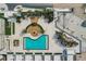 Aerial view of a meticulously designed pool and lounge area, complete with palm trees, pergolas, and stylish outdoor spaces at 5120 Marina Way # 15005, Tampa, FL 33611