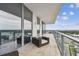 Spacious balcony with tile floor, glass railings, and comfortable patio furniture at 5120 Marina Way # 15005, Tampa, FL 33611