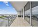 Spacious balcony featuring sleek glass railings, tile flooring, and stunning waterfront views from a modern high-rise at 5120 Marina Way # 15005, Tampa, FL 33611