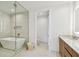 Modern bathroom with glass shower, soaking tub, and wood cabinets with white countertop at 5120 Marina Way # 15005, Tampa, FL 33611