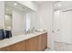 Modern bathroom featuring wood cabinets, quartz countertop, large mirror, and neutral paint at 5120 Marina Way # 15005, Tampa, FL 33611