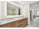 Modern bathroom with dual sinks, wood cabinets, and lighted vanity mirror at 5120 Marina Way # 15005, Tampa, FL 33611