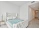 This bedroom features floor-to-ceiling windows, and a luxuriously tufted headboard and bedframe with a quilted coverlet at 5120 Marina Way # 15005, Tampa, FL 33611