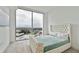 This bedroom features floor-to-ceiling windows, and a luxuriously tufted headboard and bedframe with a quilted coverlet at 5120 Marina Way # 15005, Tampa, FL 33611