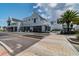 Exterior view of a new commercial building with restaurant and business signage, showcasing the modern design at 5120 Marina Way # 15005, Tampa, FL 33611
