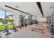 Bright gym features exercise equipment, weights, mirrored wall, and floor-to-ceiling windows with a view at 5120 Marina Way # 15005, Tampa, FL 33611