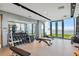 Well-lit gym featuring free weights, a rowing machine, and an open doorway with outdoor views at 5120 Marina Way # 15005, Tampa, FL 33611