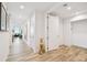Long hallway with light-colored wood flooring, a golden cat statue and views to living area at 5120 Marina Way # 15005, Tampa, FL 33611