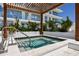 Inviting rooftop hot tub with a pergola, lush landscaping, and views of the modern building against a beautiful sky at 5120 Marina Way # 15005, Tampa, FL 33611