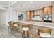Bright kitchen features wood cabinets, stainless steel appliances, a large island with seating, and modern finishes at 5120 Marina Way # 15005, Tampa, FL 33611