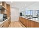 Spacious kitchen featuring wood cabinetry, an island with seating, stainless steel appliances, and modern finishes at 5120 Marina Way # 15005, Tampa, FL 33611