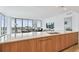Modern kitchen with island, stainless steel appliances, and access to the living room with floor-to-ceiling windows at 5120 Marina Way # 15005, Tampa, FL 33611