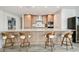 Bright kitchen with wood cabinetry, stainless steel appliances, large island with barstool seating and modern finishes at 5120 Marina Way # 15005, Tampa, FL 33611