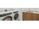 Close up of a convenient laundry room featuring a washer and dryer and sink area at 5120 Marina Way # 15005, Tampa, FL 33611