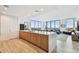 Open floor plan with sleek kitchen island flowing into living area with floor-to-ceiling windows and city views at 5120 Marina Way # 15005, Tampa, FL 33611