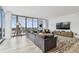 Contemporary living room features a large sectional sofa, floor-to-ceiling windows with city views, and modern furnishings at 5120 Marina Way # 15005, Tampa, FL 33611