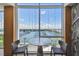 A modern lounge area with waterfront views of the marina from a marble table and comfortable seating at 5120 Marina Way # 15005, Tampa, FL 33611
