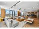Modern lounge with stylish furniture, unique wood coffee tables, and Herringbone floors, adjacent to a bar at 5120 Marina Way # 15005, Tampa, FL 33611